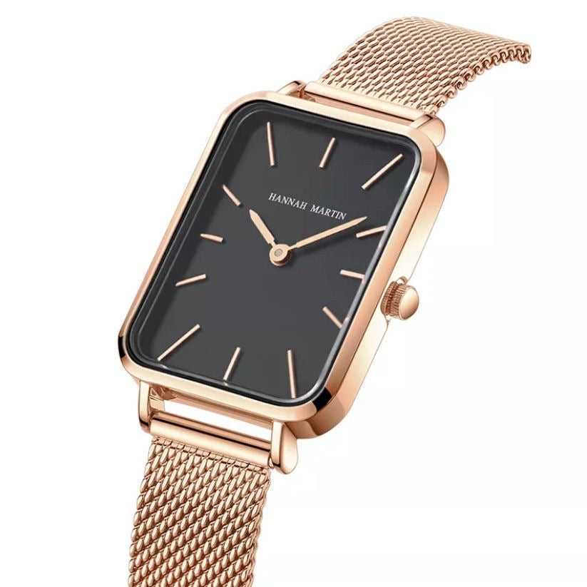 Rose gold watch with black face on a white background