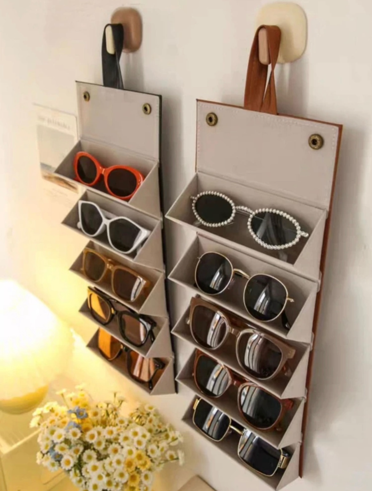 Multifunctional sunglasses storage organizer with sunglasses inside, hanging on a wall.