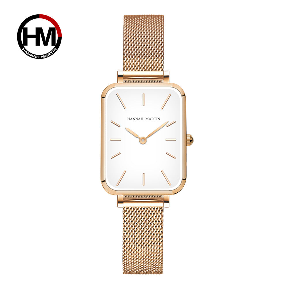 Gold watch with white face on a white background, featuring the Hannah Martin logo.