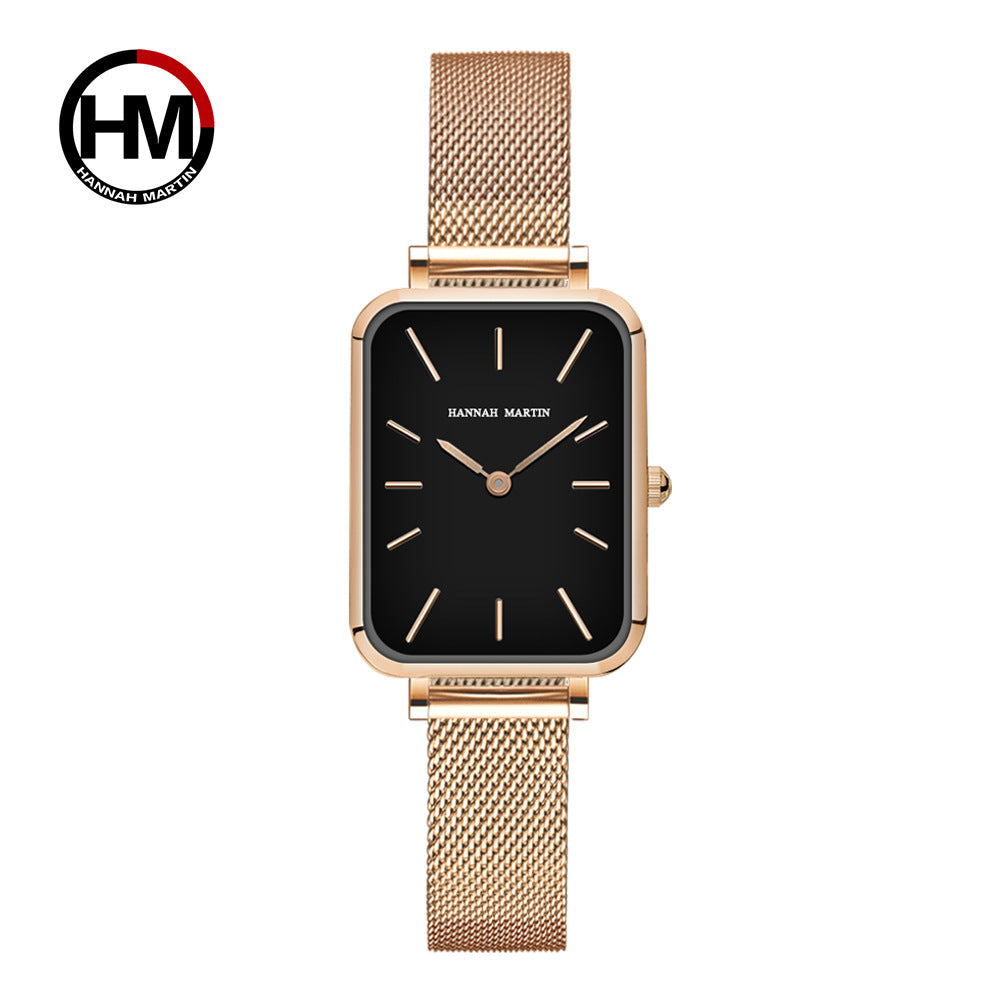 Gold watch with black face on a white background, featuring the Hannah Martin logo.